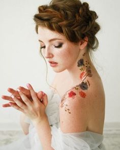 a woman with tattoos on her arm and chest