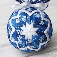 a blue and white ornament with snowflakes on it's side