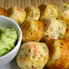 a bowl of guacamole next to some fried food