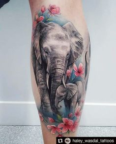 an elephant with pink flowers on his leg