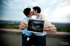 a man and woman kissing while holding up an x - ray image in front of them