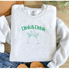 Dink and Drink Pickleball Sweatshirt for Pickleball Players  Welcome to Products by Lauren!! If you are looking for soft, comfy, trendy apparel, you're in the right place! I love what I do and strive to make your shopping experience just right for you. If you have any questions, concerns or comments about my products, feel free to send a message anytime.  Custom Personalized Unisex Sweatshirt, .: 50% cotton, 50% polyester .: Medium-heavy fabric (8.0 oz/yd² (271.25 g/m .: Loose fit .: Sewn-in label .: Runs true to size HOW TO PLACE ORDER 1. Check photos for size chart, model comparison and color options 2. Select size and color from the drop down options 3. Purchase your item SHIRT SIZING Please note that these sweatshirts are unisex size meaning they are not fitted. If you're going for a m Pickleball Sweatshirt, Alabama Sweatshirt, Drink Accessories, Pickleball Shirt, Santa Sweatshirt, Pickleball Gift, Retro Tops, University Of Tennessee, University Of Alabama