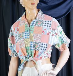 a mannequin wearing a colorful shirt and white shorts