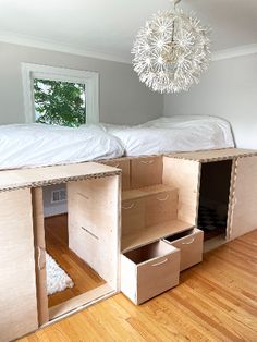 two bunk beds are built into the wall in this room with wood flooring and white walls