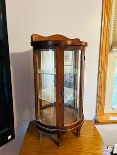 a wooden display case sitting on top of a table