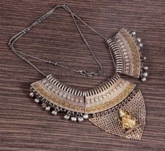 Here is a beautiful piece of Rajasthani silver necklace that is the perfect addition to your wardrobe as you can wear it with just about anything. The best part about this neckpiece is that it is very adaptable to its surroundings.  #etsy #necklace #dualtone #templejewelry #choker #aadhyatrends Metal Necklaces For Weddings And Festivals, Wedding Necklaces For Festivals, Festive Wedding Necklaces In Metal, Silver Bridal Necklace With Intricate Design For Celebration, Silver Bridal Necklace For Festive Celebration, Silver Necklace For Wedding And Festivals, Silver Temple Bridal Necklace For Wedding, Silver Wedding Necklace For Festivals, Metal Bridal Necklace For Wedding