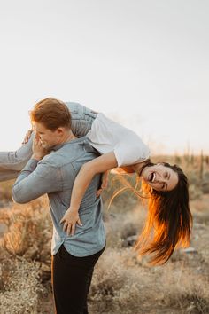 a man carrying a woman on his back in the desert