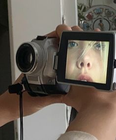 a person holding a camera up to their face