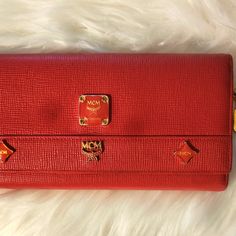 Pebbled Red Safion Leather Long Wallet That Has These Adorable Charms Hanging From The Side Of Her. Wallet I In Immaculate Condition With No Call Outs Whatsoever To My Knowledge. Has Multi. Compartments For All Ur Wallet Needs. Also Includes Many Card Slots, Cash Bill Slot,And Places For Id's. (Matches Mcm Boston Bag I Have In Closet. Please Lmk If U Want To Bundle Them For A Better Price Please Mcm Bags, Boston Bag, Long Wallet, Red Gold, Bag Lady, Wallet, Red, Leather, Women Shopping