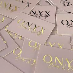 many different types of letters and numbers on white paper with gold foiled lettering that spell out the alphabet