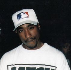 a man wearing a baseball cap and t - shirt