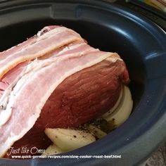 ham and onions in a slow cooker ready to be cooked