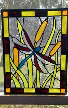 a stained glass window with a dragonfly on it