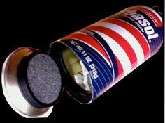 an open can of soda sitting on top of a black surface with white and red stripes