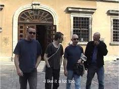 three men standing in front of a yellow building with the words like it's lot too