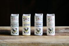 three different types of salt and pepper shakers on a wooden table with black background