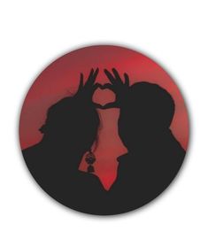 the silhouette of two people making a heart shape with their hands in front of a red sky