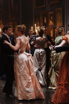 a group of people in formal dress dancing