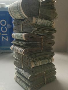 a stack of money sitting on top of a table