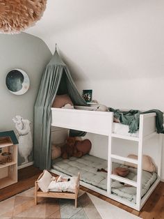 a child's bedroom with bunk beds and toys on the floor in front of it