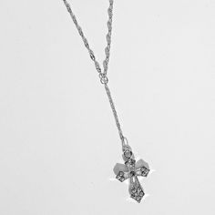 Silver rosary necklace featuring a crystal cross. MEASUREMENTS Chain length: 14" inches + 2" inch extension chain (16" inches total) Drop length: 3" inches Charm measurements: 25 x 27 mm MATERIALS Chain material: Stainless steel Charm material: Silver plated brass Crystal Cross Necklace With Adjustable Chain, Crystal Cross Jewelry With Adjustable Chain, Rhinestone Cross Necklace With Adjustable Chain As Gift, Silver Cross Lariat Necklace With Adjustable Chain, Adjustable Silver Cross Lariat Necklace, Adjustable Cross Lariat Necklace, Adjustable Clavicle Chain Cross Necklace, Silver Rosary, Jewelry For Girls