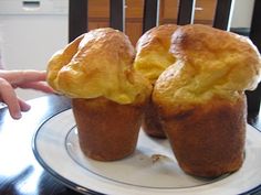 two muffins sitting on top of a plate with one being held up by the other