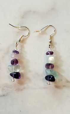 ⋄ Fluorite is a stone heralded for its spiritual detoxification abilities and tendency to transform negative energy into positive energy, boosting our mental clarity and     promoting peace of mind.  ⋄ Handmade dangle earrings made with high-quality fluorite stones and glass seed beads that hang on sterling silver ear wires ⋄ Total length of earring is 2 inches.    ⋄ Earrings are light and comfortable to wear. Great for any occasion. ⋄ Fluorite is a stone heralded for its spiritual detoxificatio Healing Gemstone Dangle Jewelry, Spiritual Style Dangle Jewelry With Natural Stones, Spiritual Dangle Jewelry With Natural Stones, Spiritual Gemstone Dangle Jewelry, Spiritual Natural Stone Drop Earrings, Dangle Gemstone Jewelry For Meditation, Spiritual Teardrop Jewelry For Healing, Spiritual Healing Teardrop Jewelry, Spiritual Amethyst Drop Earrings