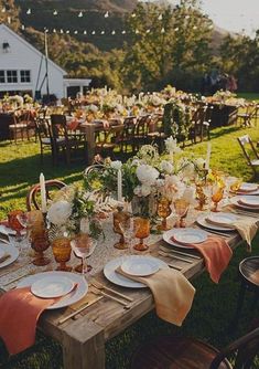 an outdoor table set with plates and place settings