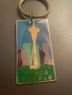 a metal keychain with a space needle on it