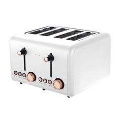 a white toaster sitting on top of a white table next to two black and gold knobs