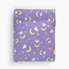 a bed with purple and yellow stars, moon and mickey mouse pattern on the cover