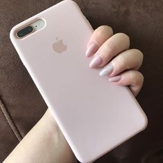 a woman's hand holding an iphone case