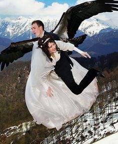 a man and woman dressed in wedding clothes flying through the air with an eagle on their back