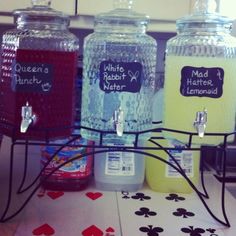 three jars with labels on them sitting on a table next to cards and playing chips