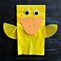 a yellow paper bag with eyes on it and the words paper bag duck in front of it