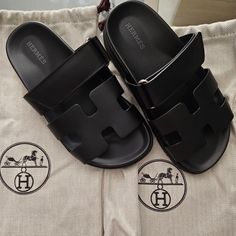 Authentic Black Leather Hermes Chypre Sandals. Women's Size 34. With Dust Bags. Brand New Never Worn. Got These As A Gift And Sadly Doesn't Fit Me. Gifter Bought At Hermes In France; I Don't Have The Receipt Or Box But As You Can See In Pics, It's Brand New Never Worn Condition. Hermes Cypress Sandals, Luxury Black Calf Leather Slides, Elegant Black Slides With Branded Insole, Black Leather Slides For Evening, Evening Black Leather Slides, Designer Black Slides For Formal Occasions, Luxury Black Sandals, Luxury Black Open Toe Slides, Hermes Shoes Women