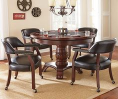 a dining room table with four chairs around it