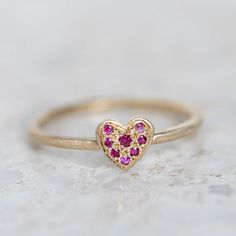 Our take on fine sweet little stacking rings. Layer them up and mix your metals! The Pave Diamond Mini Heart Stacking Ring is pave set with pink sapphires - perfectly mixed with the little groove band or tiny dot ring. Pink sapphires each measure 1.25mm. Sapphires are the birthstone of September. Heart measures 6.5 x 7mm. Band width 1.5mm Weight 1.5 approx. Pictured here with a high shine finish. For a matte finish please leave a note at checkout. Clothing Wishlist, Dot Ring, Golden Ring, Mini Heart, Stacking Ring, Style Accessories, Stacking Rings, Pink Sapphire, Pave Diamonds