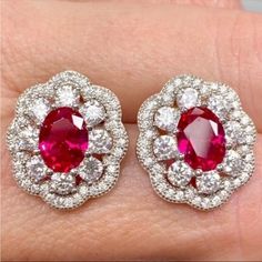 Anna Zuckerman Luxury Victoria 10 Carat Ruby Halo Stud Earrings In 925 Sterling Silver New!! Luxury Designer Azl Retail Price: $199 10 Carat Total (5 Ct Each Earring) 3 Carats Ruby (1.5 Ct Each Earring) 5 Carats (Total) Diamond Crystalline (2.5 Ctw Each Earring) Solid 925 Sterling Silver With Rhodium Plating Includes Gift Box & Jewelry Polishing Cloth July Birthstone Stunning Statement Jewelry! Each Earring Has A Faceted 1.5 Carat Oval Ruby Coated With Diamond Crystalline With 2.5 Carats Of Roun Art Deco Ruby Earrings, Gia Certified Ruby Earrings For Anniversary, Red Diamond Hallmarked Earrings, Classic Red Diamond Earrings, Aaa Quality Red Jewelry For Formal Occasions, Classic Ruby Earrings With Halo Design, Classic Ruby Halo Design Earrings, Classic Ruby Halo Earrings, Classic Red Ruby Earrings