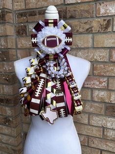 a white mannequin wearing a football scarf