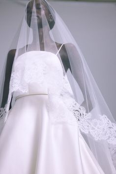 a bride's wedding dress and veil on display