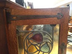 a close up of a glass window on a wooden table with chairs in the background