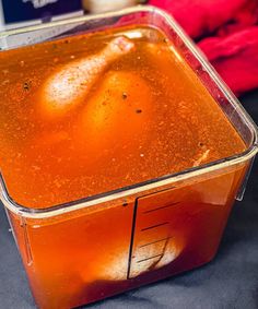 a plastic container filled with liquid sitting on top of a table