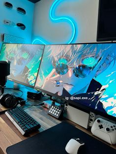 two computer monitors sitting on top of a wooden desk