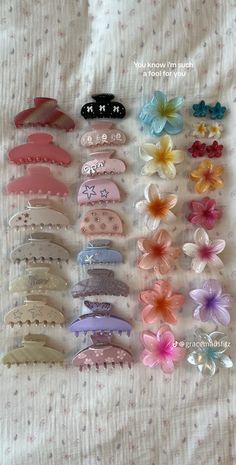 many different types of hair clips on a bed