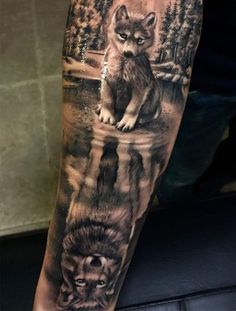 a man's arm with a wolf and lion tattoo on the left upper arm