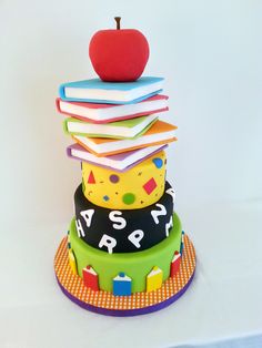 a stack of books and an apple on top of each other with the words happy birthday written on them