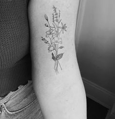 a black and white photo of flowers on the arm