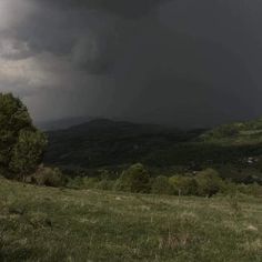 a storm moving through the sky over a valley