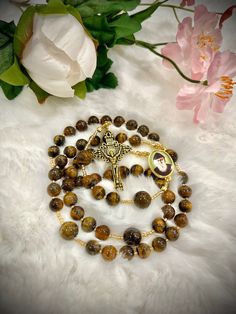 WELCOME TO OUR SHOP  This is Stunning Saint Charbel handmade rosary. Natural Tiger eye stone beads! Gorgeous St. Charbel center piece & unique gold crucifix! Top quality is no exception, thoughtfully designed and carefully made with the finest material.  Custom orders with personalized names, pictures and bulk orders are AVAILABLE :) Thank you for choosing us for your special occasion (Baptism, Birthday,  Communion, Wedding, anniversary). Custom names are $3 per letter!  Add our shop to your favorites so you can be notified with our new product! Follow us on Instagram @jmjcatholicshop  We are truly happy and beyond blessed to be able to do what we love and make people happy with our rosaries. Thank you all for your love & support. May God bless you and mother Mary protect you & your loved Gold Rosary With Gemstone Beads Gift, Gift Rosary With Round Natural Stones, Round Beads Rosary With Natural Stones For Gift, Gift Rosary With Polished Beads And Cross, Gift Rosary With Polished Beads, Wedding Rosary With 8mm Beads Cross, Beaded Brown Rosary Gift, Brown Beaded Rosary As Gift, Brown Beaded Rosary Gift